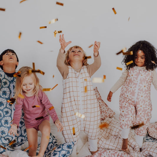 Kinderen die spelen en genieten in slaapzakken met vrolijke prints, waaronder camel check en bloemenpatronen.